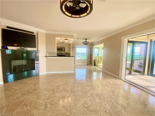 Living room featuring fireplace and crown molding