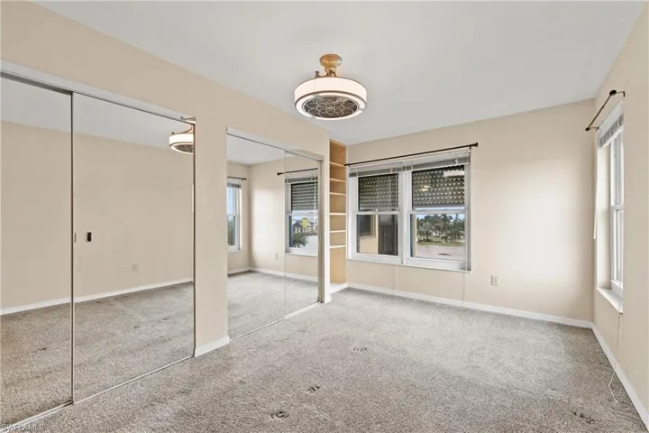 Unfurnished bedroom with carpet flooring