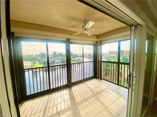 Balcony overlooking water view with ceiling fan