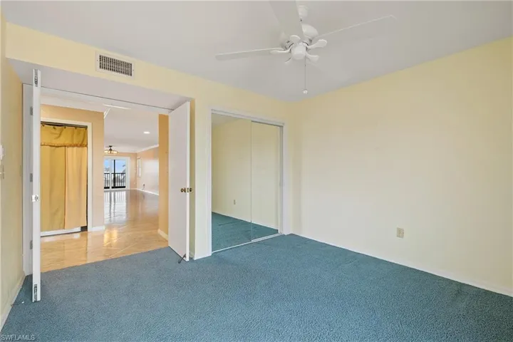 Unfurnished bedroom with a closet, carpet, and ceiling fan
