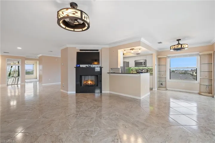 Unfurnished living room with crown molding