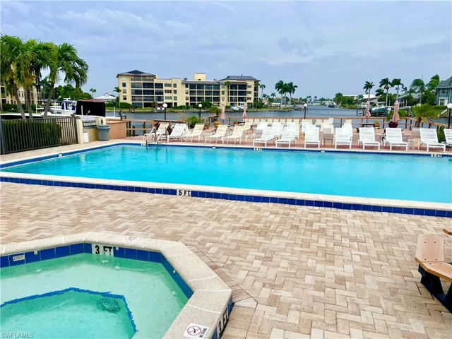 View of community swimming pool and hot tub