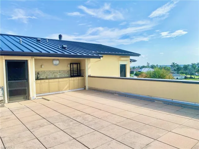 Private rooftop patio with outdoor sink and cabinetry