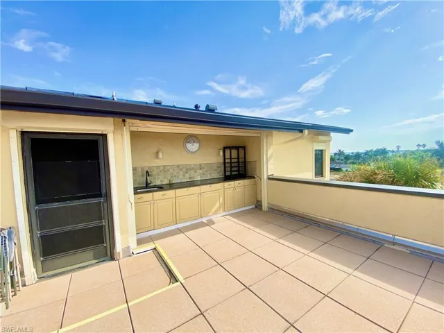 Private rooftop patio with outdoor sink and cabinetry