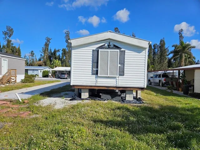 View of rear of property featuring a yard