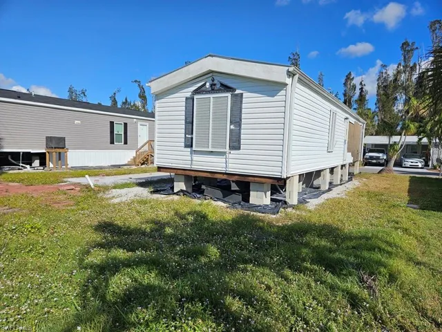 View of side of property featuring a lawn