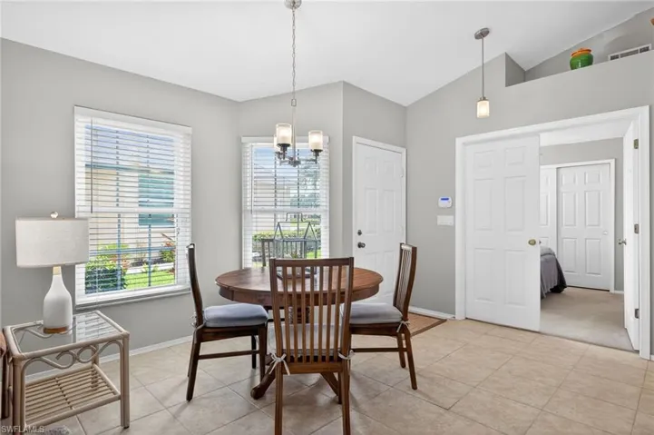Dining area with lofted ceiling and a chandelier