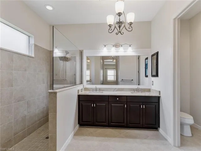 The Primary Ensuite' has a large shower, double sink vanity, and private water closet