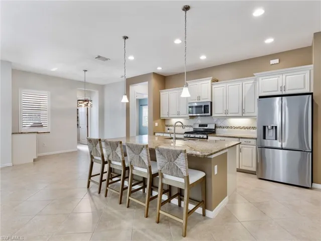 Gas Range and stainless appliances.  New large French Door refrigerator is a perfect fit.