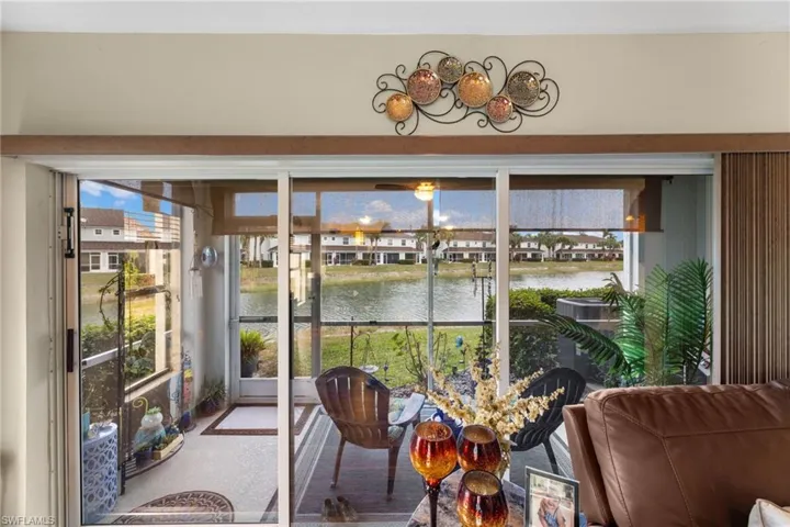 Sunroom featuring a water view