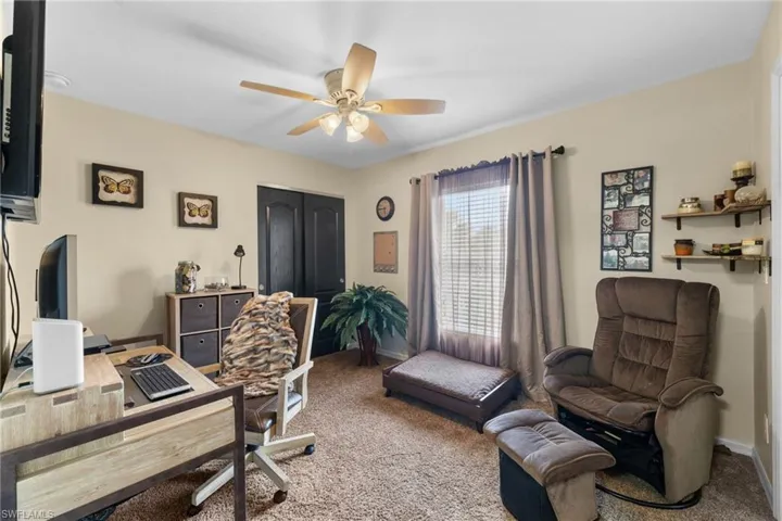 Office space with ceiling fan and carpet flooring
