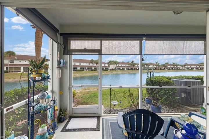 Sunroom / solarium with a water view and a healthy amount of sunlight