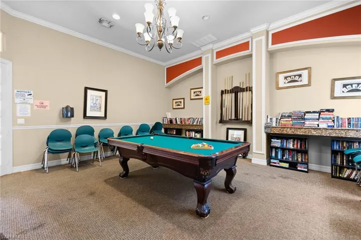 Rec room with crown molding and carpet flooring