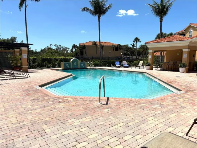 Community pool with a patio