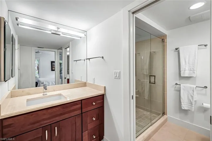 En-suite bathroom  with granite counter tops,tile floors and pocket doors