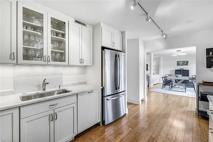 Kitchen featuring glass insert cabinets filled with beautiful dishes, glasses,eating utensils and much more