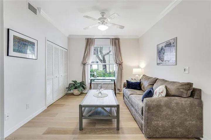 BEDROOM 3 HAS A QUEEN SIZE PULLOUT SOFA, DESK, LARGE WALK-IN CLOSET WITH FRENCH DOORS AND COASTAL HARDWOOD FLOORS, CROWN MOLDING AND FAN WITH LIGHT