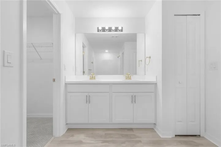 Bathroom featuring hardwood / wood-style floors and double vanity