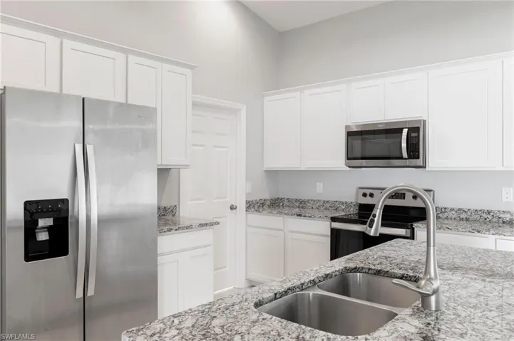 The Center Island Kitchen features granite surfaces, high end Moen fixtures and raised panel cabinetry