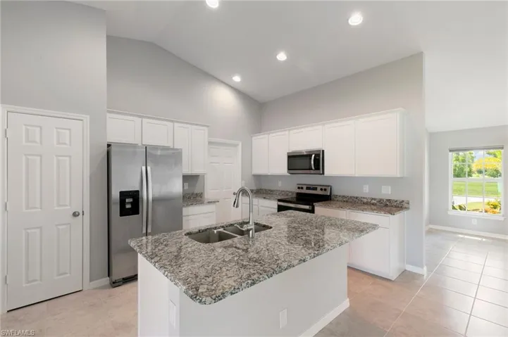 Center Island Kitchen with granite surfaces, stainless appliances, soft close cabinetry & plenty of storage!