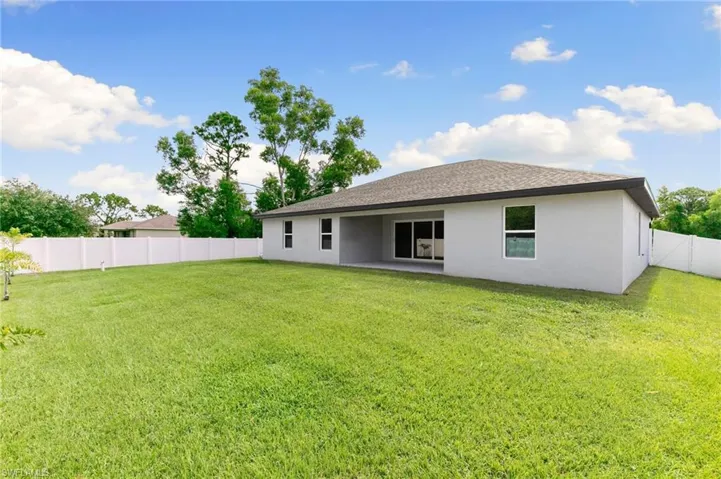 Step out onto the covered Lanai and enjoy the privacy of a fully fenced backyard.  Plenty of room for a pool!