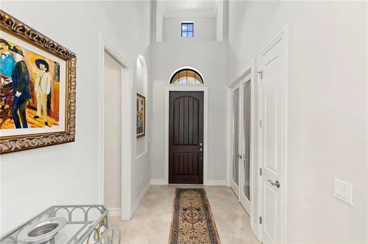 Foyer entrance featuring a high ceiling and baseboards