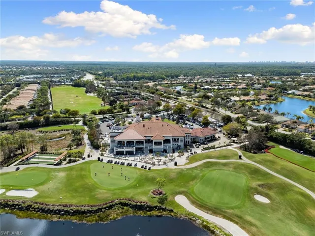 Aerial perspective of suburban area featuring a large body of water and a golf club