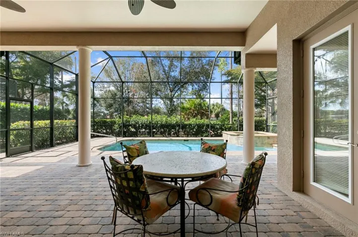 Sunroom / solarium featuring a patio area, ceiling fan, a jacuzzi, and a swimming pool