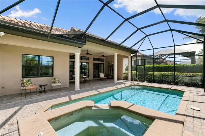 Integrated pool / spa featuring a sunroom, a patio area, and a lanai