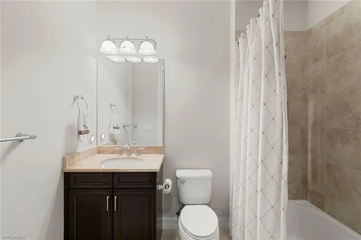 Bathroom with vanity and shower / bath combo with shower curtain