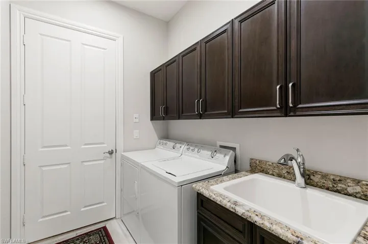 Laundry area featuring washer and dryer and cabinet space