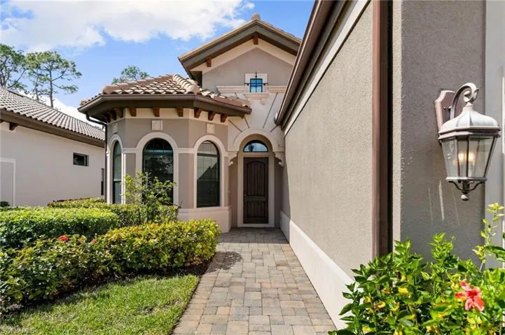 Doorway to property featuring stucco siding