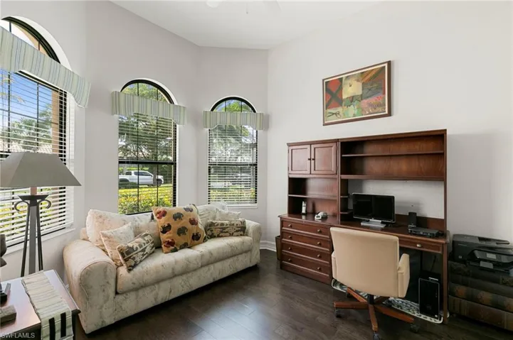 Office area featuring dark wood finished floors and a ceiling fan