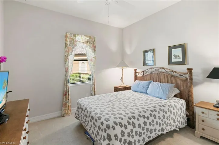 Bedroom featuring light carpet and ceiling fan