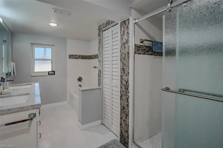 Bathroom featuring vanity and plus walk in shower