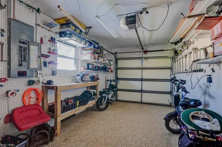 Garage with a garage door opener and a workshop area