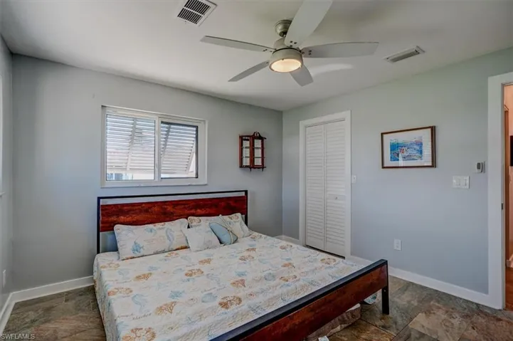 Bedroom with ceiling fan and a closet