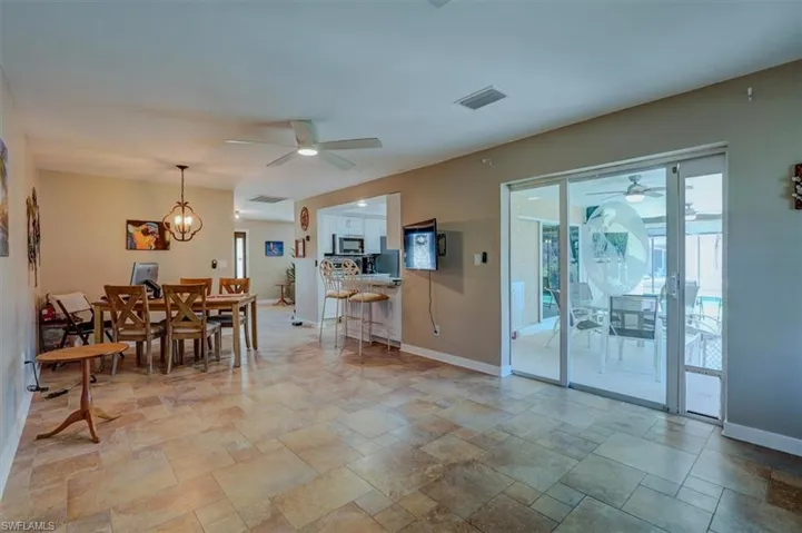 Dining area featuring ceiling fan with notable chandelier