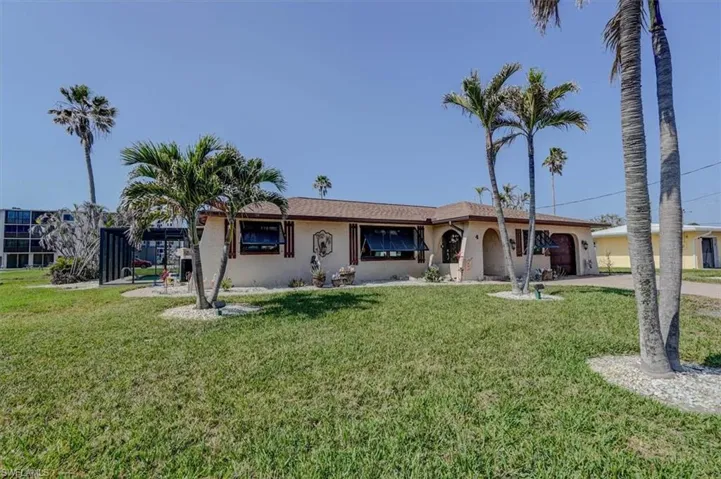 Ranch-style house with a garage and a front yard