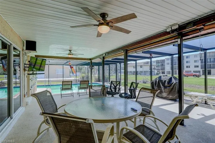 Sunroom featuring a swimming pool