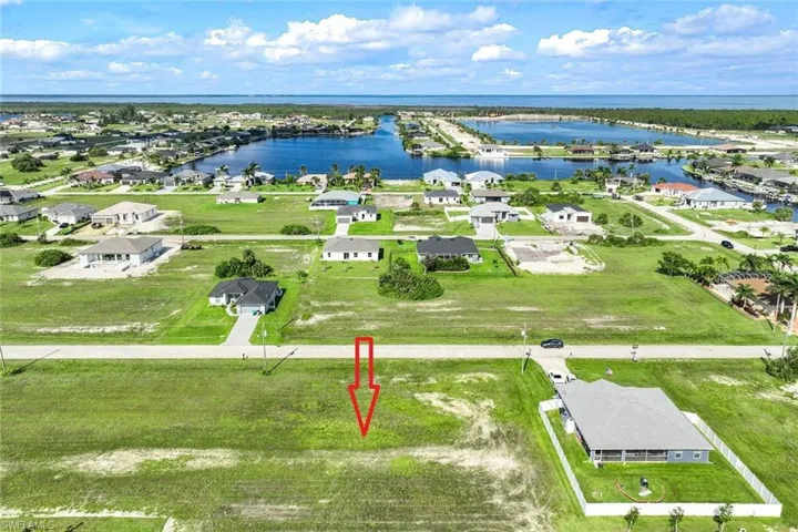 Birds eye view of property with a water view