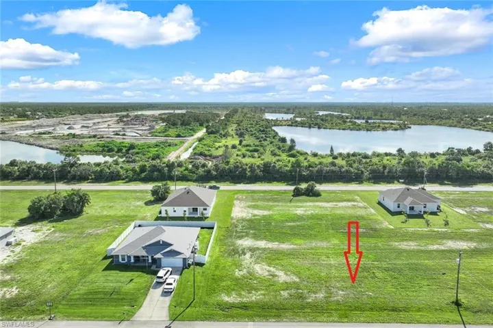 Birds eye view of property with a water view