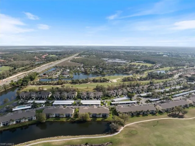 Birds eye view of property with view of golf course, a water view, and a residential view
