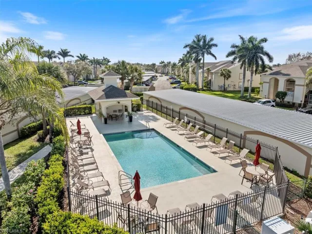 Pool featuring a gazebo, a residential view, fence, and a patio