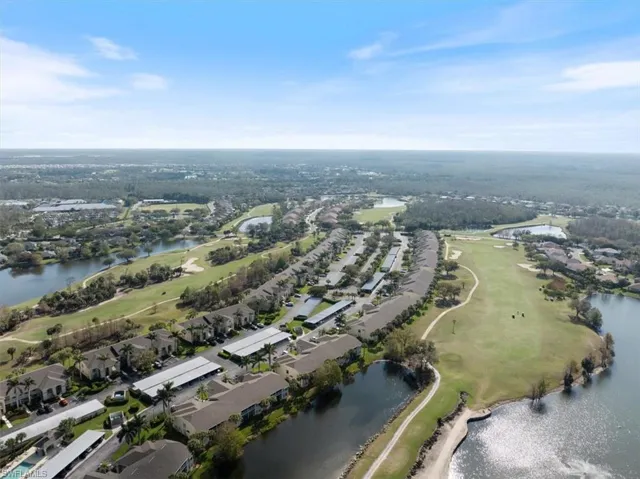 Bird's eye view with a water view and view of golf course
