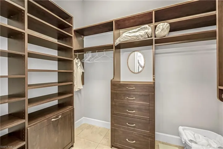 Walk in closet with light tile patterned floors