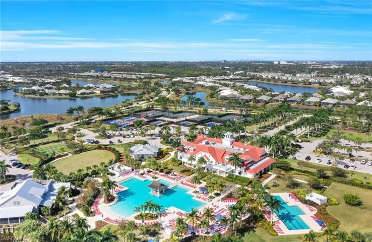 Drone / aerial view of a pool and a nearby body of water