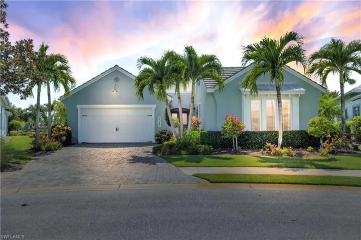 Ranch-style home with decorative driveway, stucco siding, and an attached garage