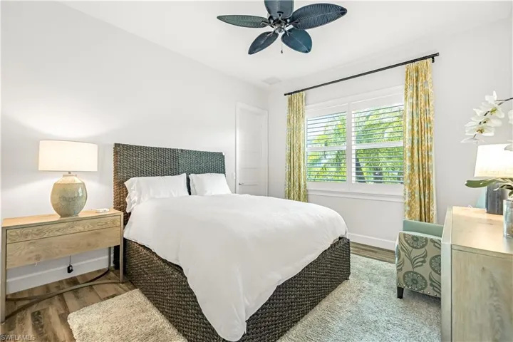 Bedroom with wood finished floors and ceiling fan