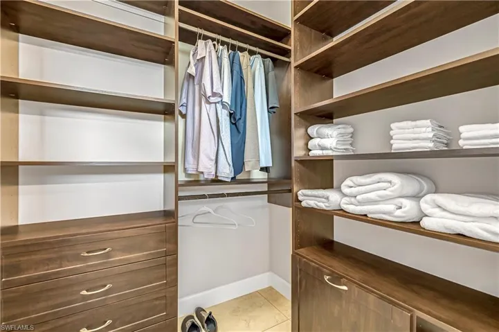 Spacious closet with light tile patterned floors
